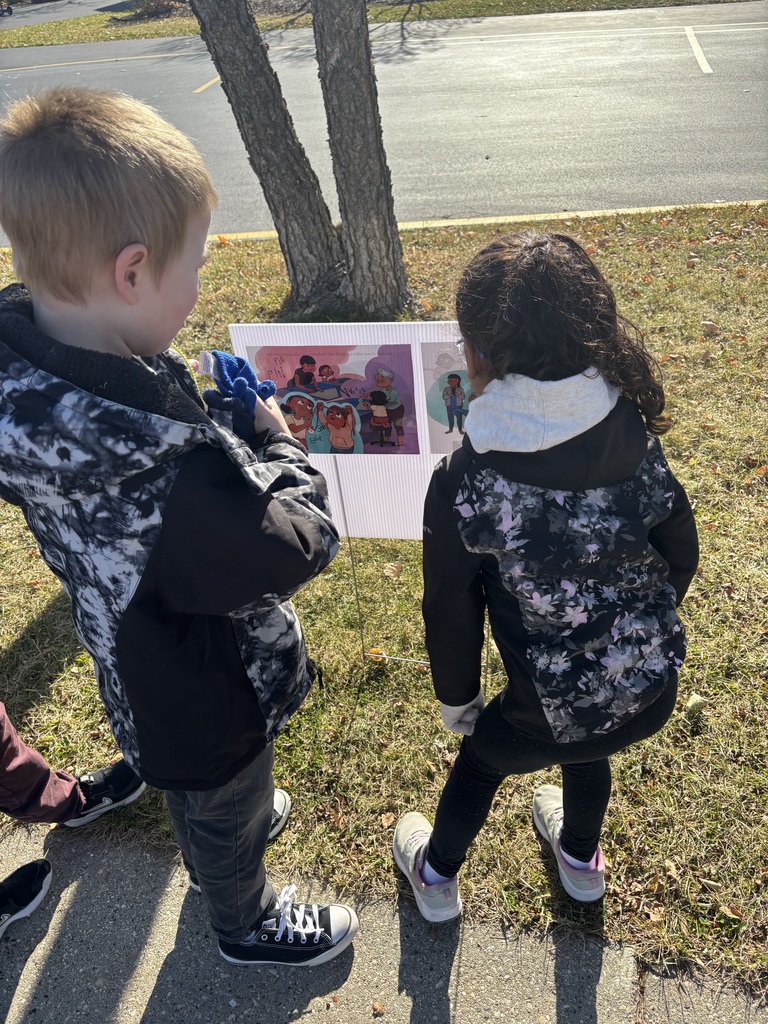 Students looking at 2025 Storywalk at College Park
