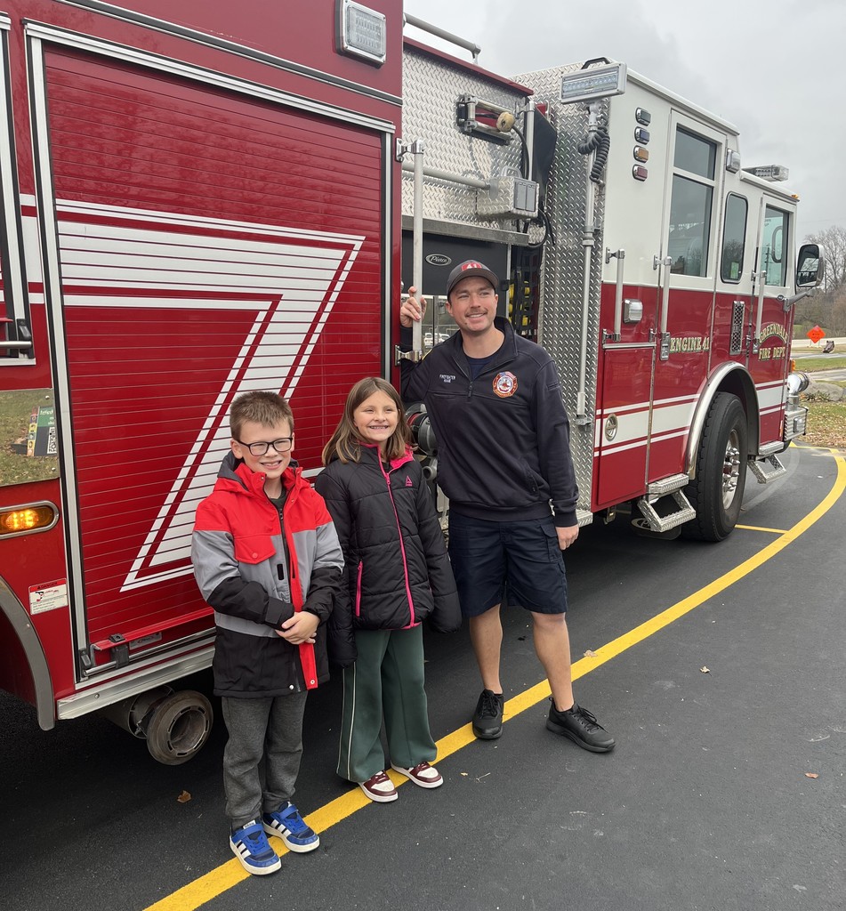 Two Students with a Greendale Fire Fighter and Fire Truck