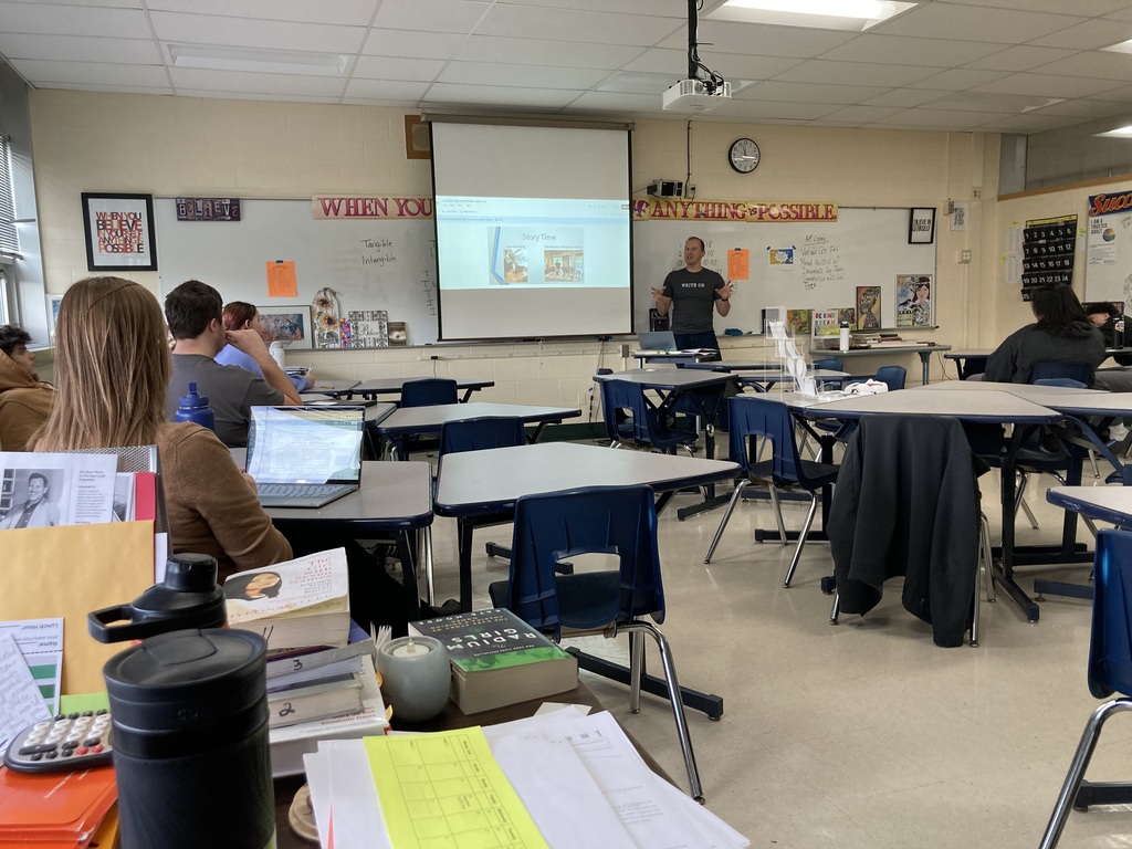 Slater speaking to students with some students showing.