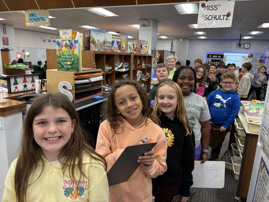 Students smiling and walking through the school.