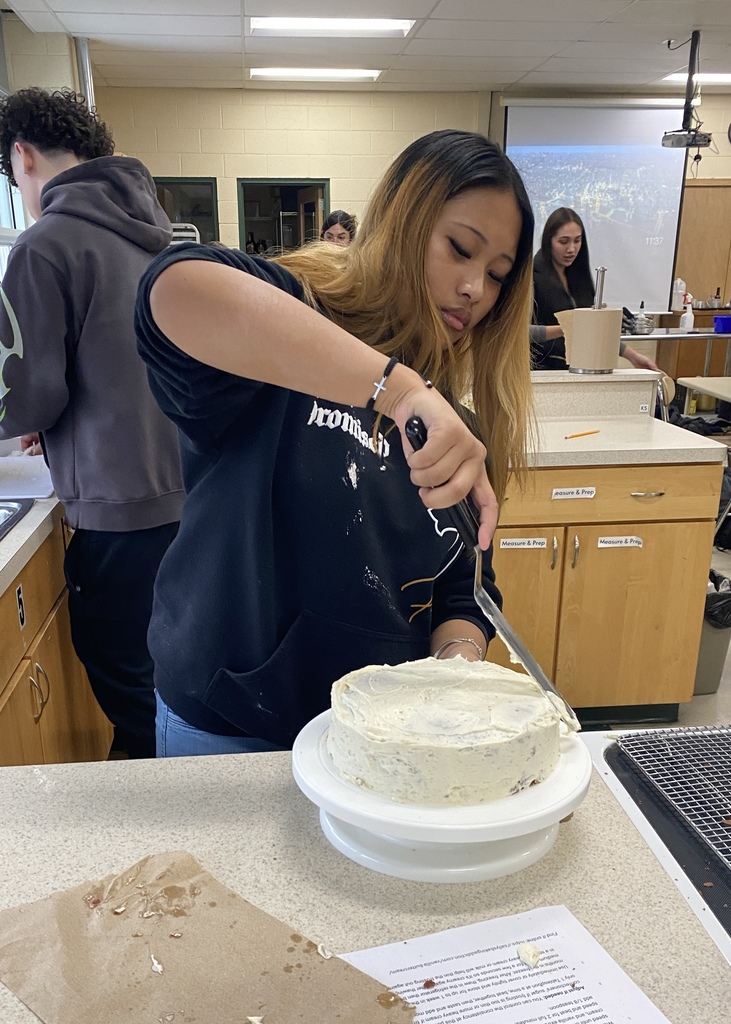 Piping frosting on a cake
