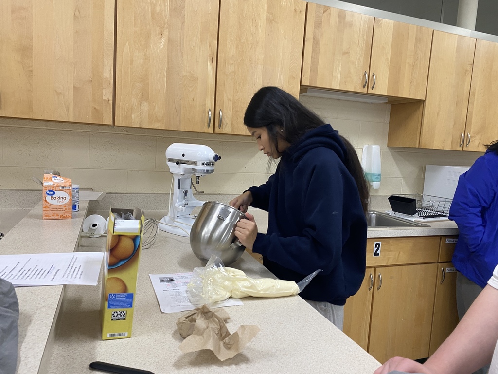 Student decorating a cake