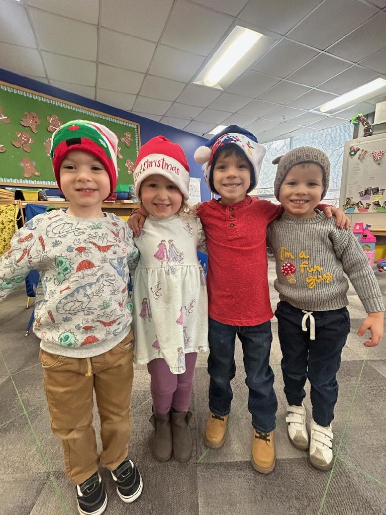Cute 4K kiddos smiling for camera on hat day