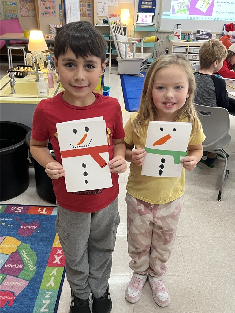 Students showing their snowman cards.