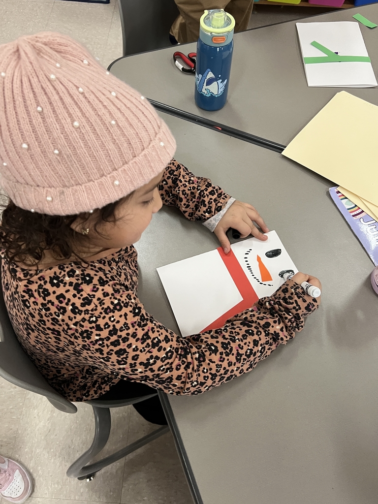 Student making a snowman card.