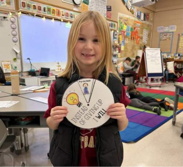 Students Holding Their Work After Learning About Perseverance