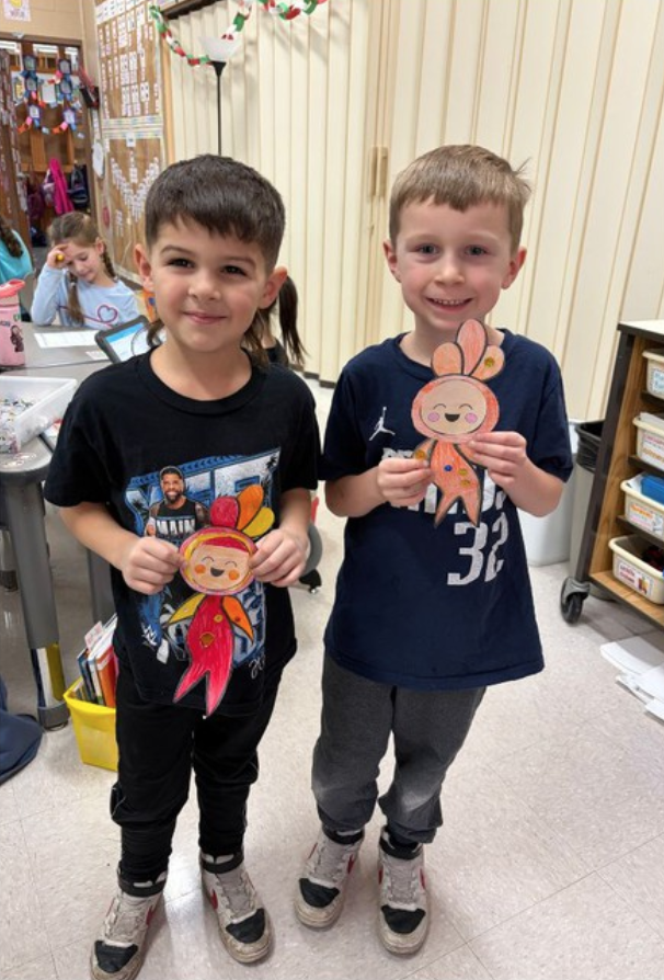 Students Holding Their Work After Learning About Perseverance