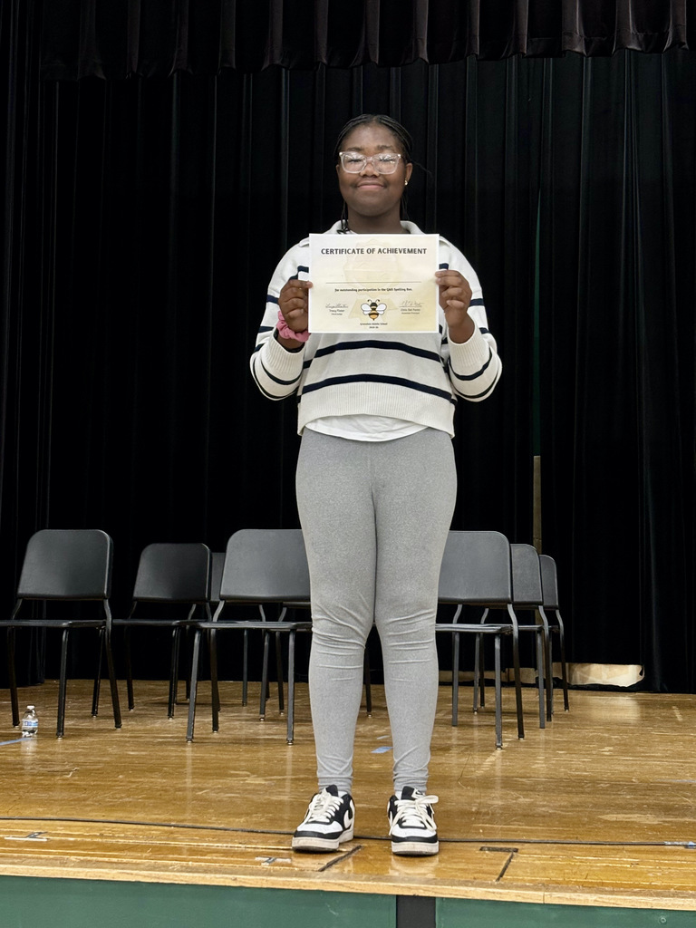 Spelling Bee winner with certificate.