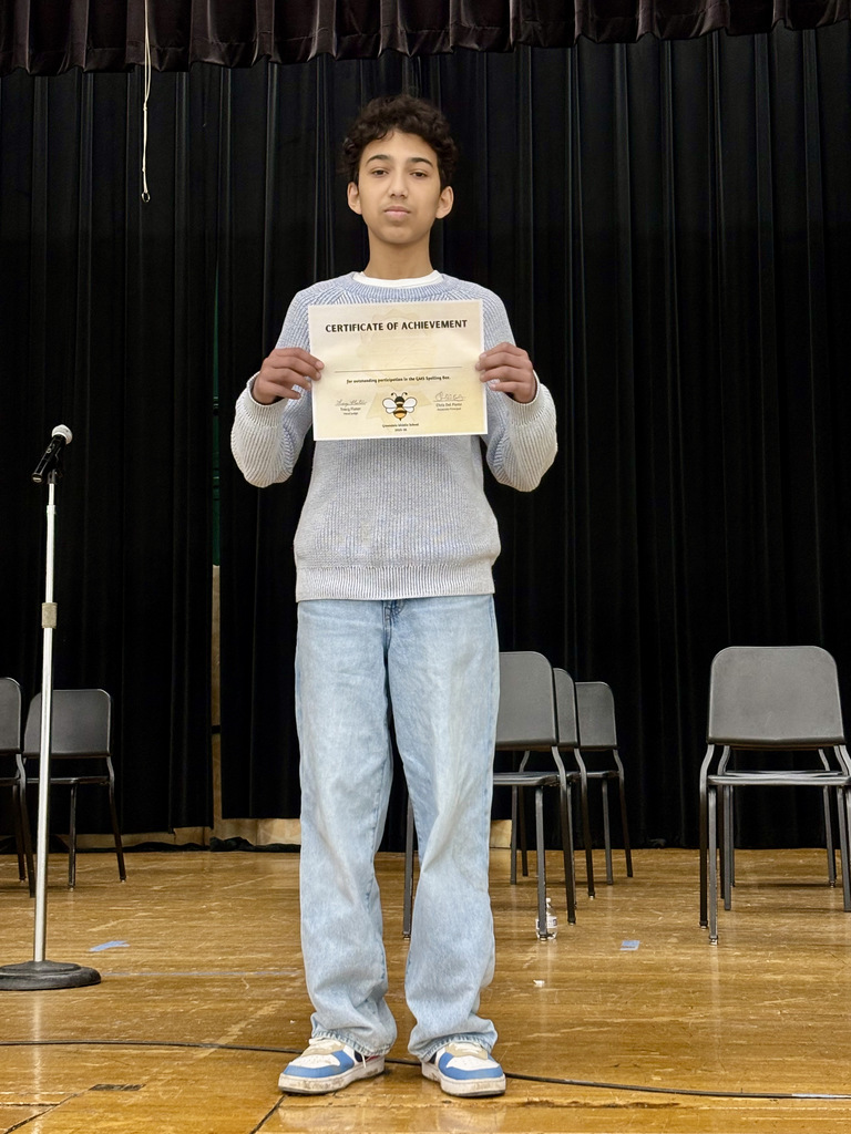 Spelling Bee finalist with certificate.