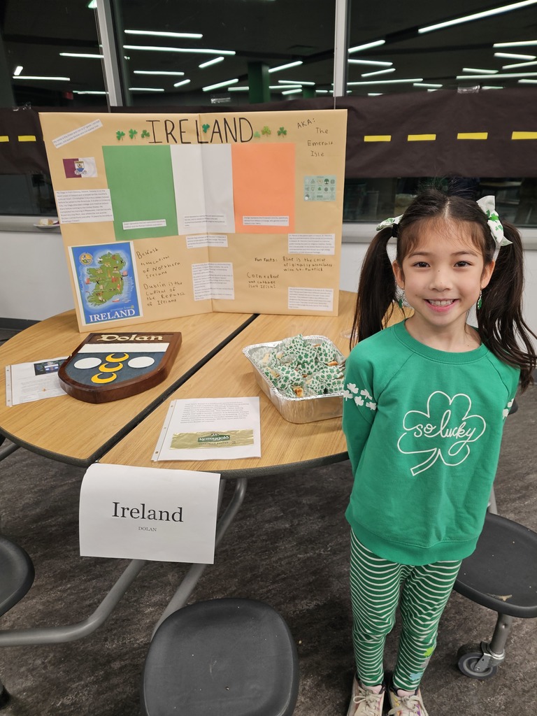 Girl Stands By the Table Shared by Her Family at All the World Event