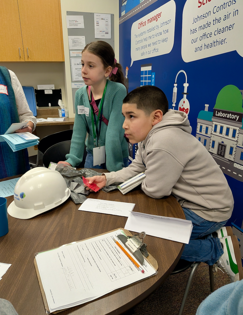 A girl and boy getting instruction for their "job" at BizTown simulation