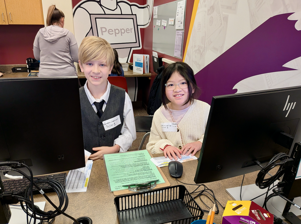 Boy and girl work as tellers at JA BizTown simulation