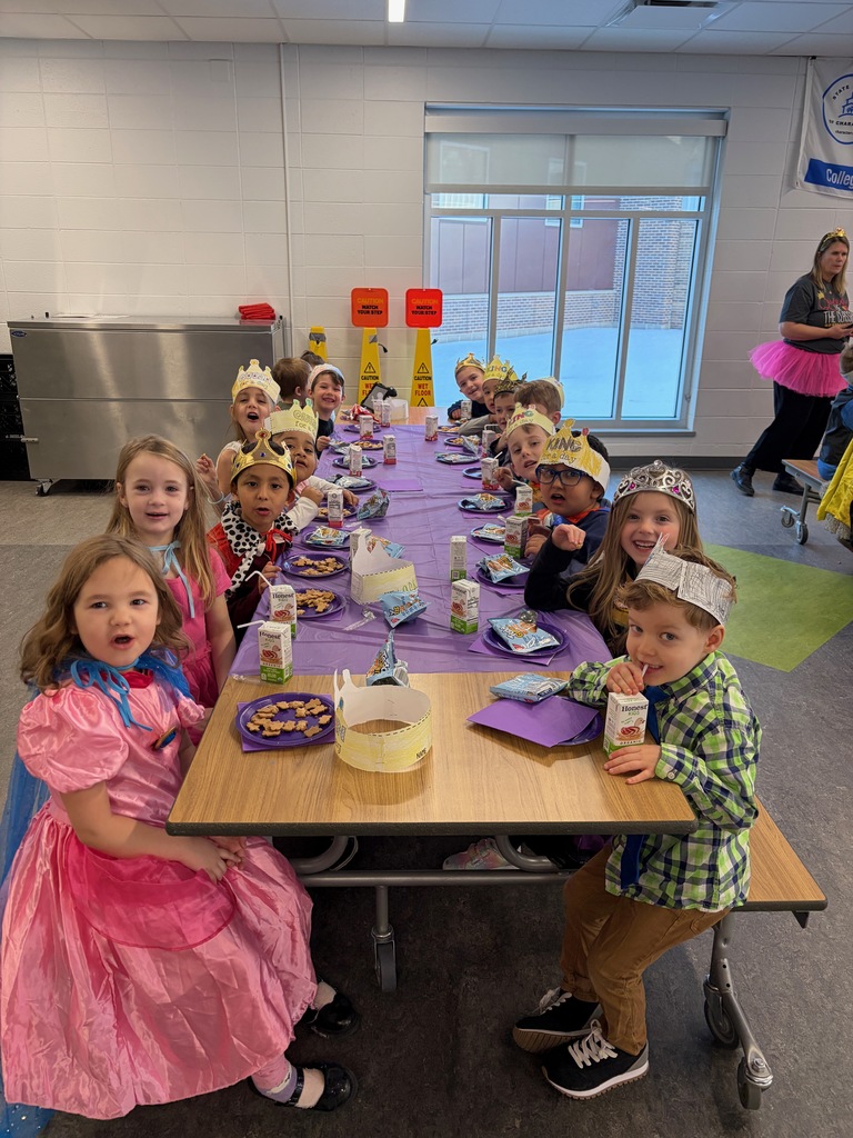 A long lunch table filled with smiling Kings and Queens