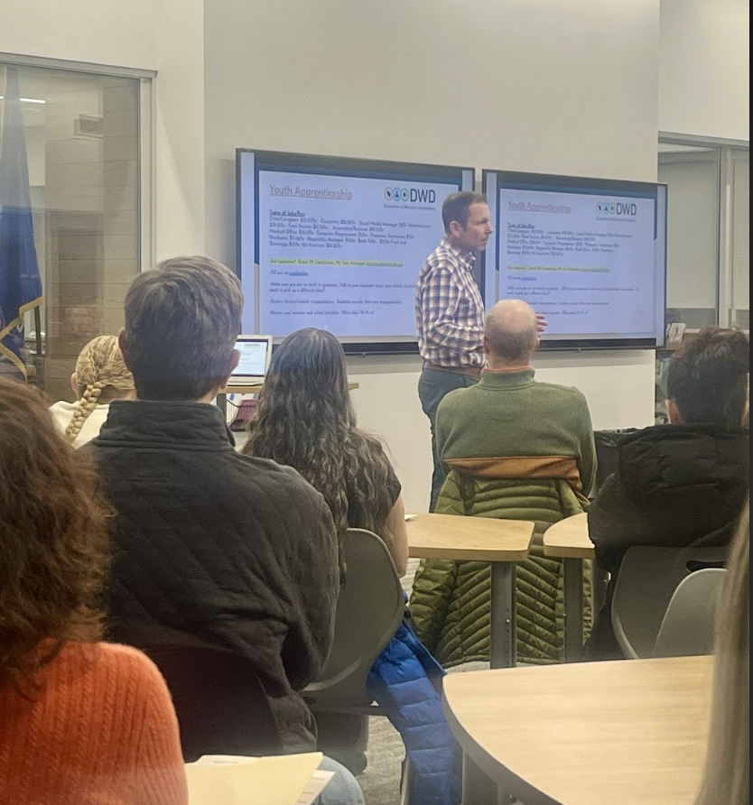 Parents and students listening to counselors share info on career pathways opportunities.