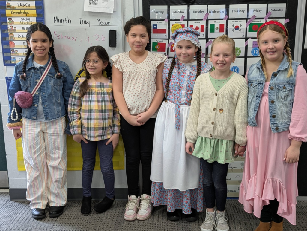 Girls posing in Western apparel.