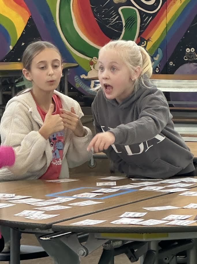 An enthusiastic Battle of the Books participant talking through answers with a teammate.