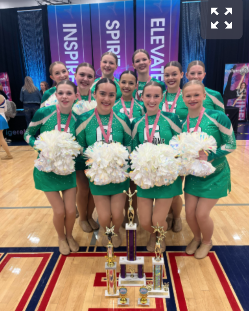 Poms posing with their medals, trophies and poms after their wins at the Wisconsin Spirit Championship.
