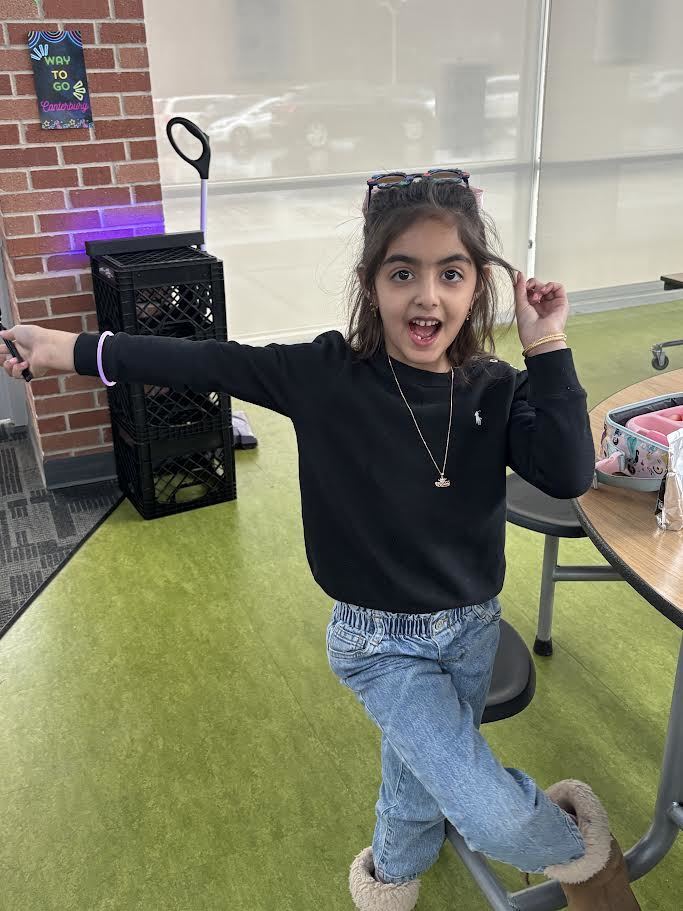 Smiling girl poses with a glow bracelet at fun Glow reward Lunch.