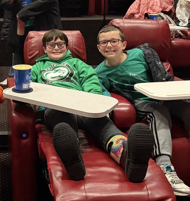 Two boys smiling at all-school movie field trip.
