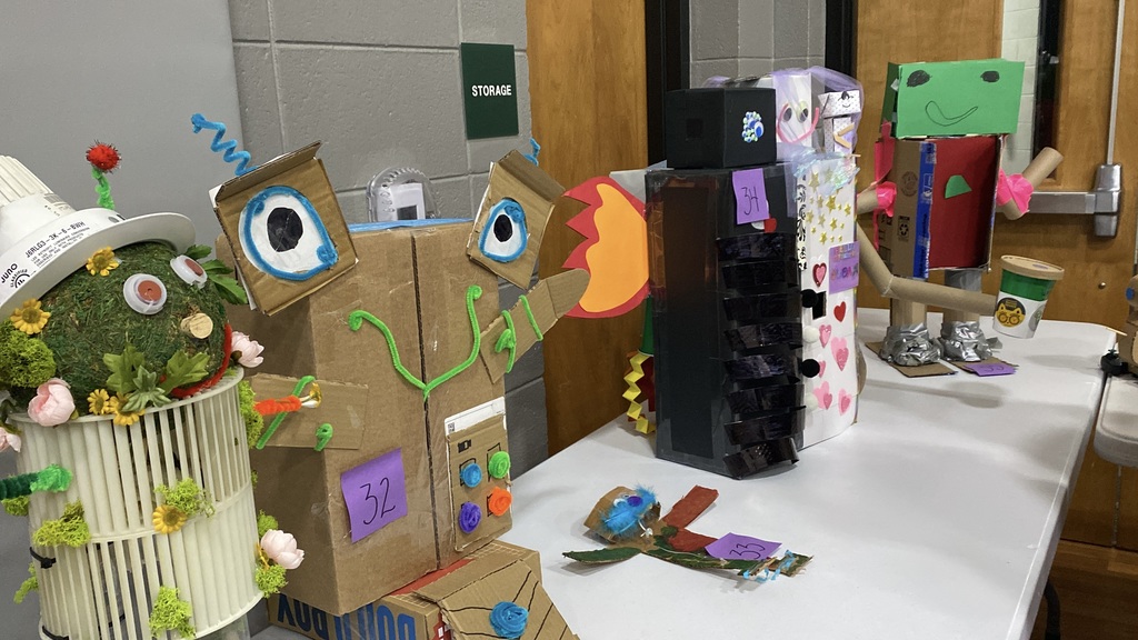 Five colorful and creative robot figures displayed on a table