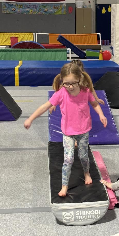 5K girl testing her balance skills at Altius Gymnastics.