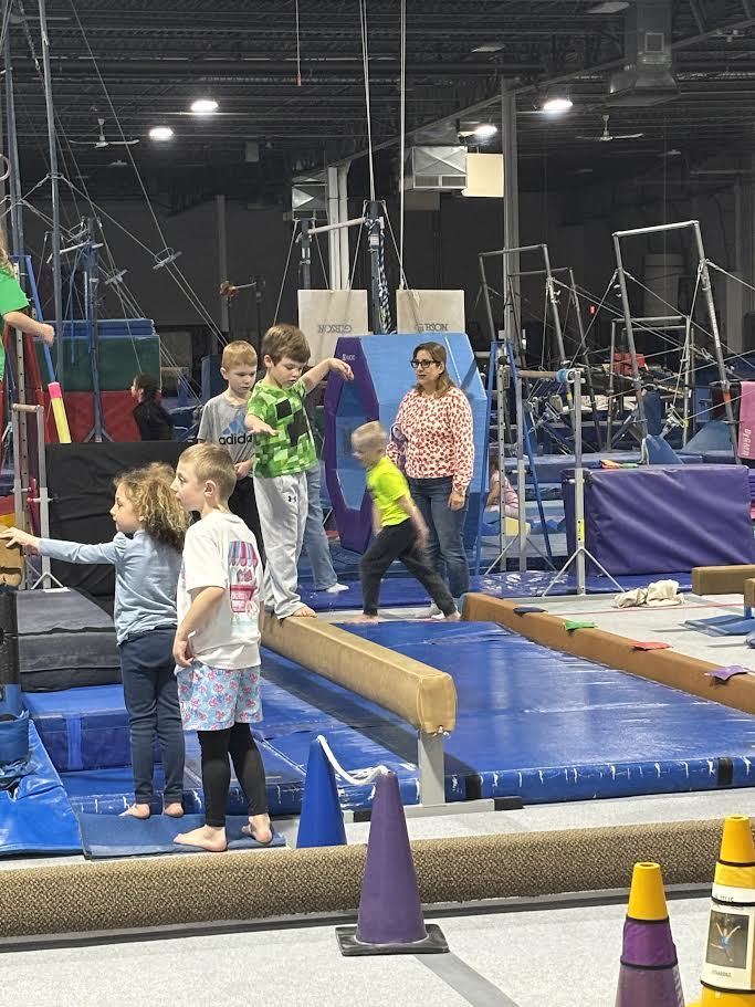 5K students at Altius Gymnastics gym trying out the balance beam.