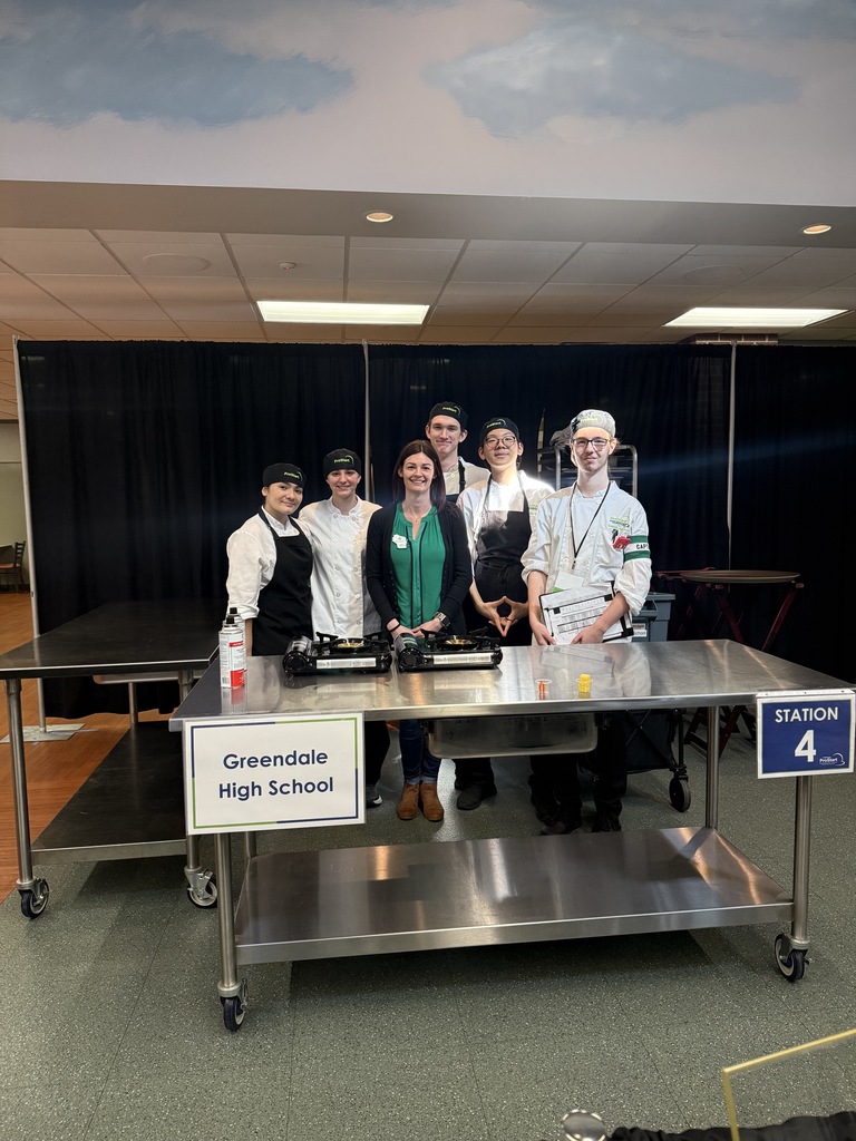 Culinary Team and Teacher posing in their competition area.