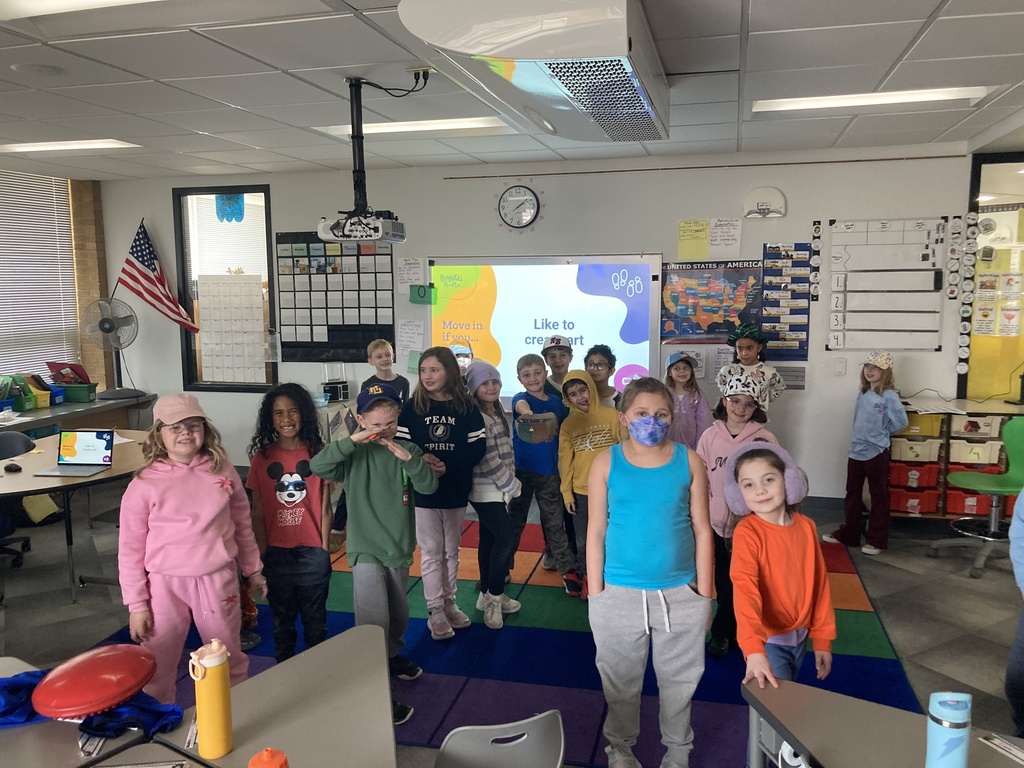 A group of students moving around the classroom in a fun game that requires cooperation.