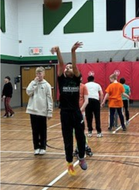 Boy shooting a basket.