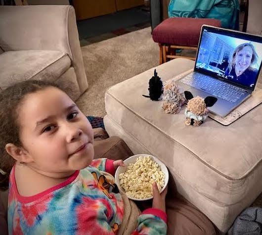 Girl watching a story told over Zoom.