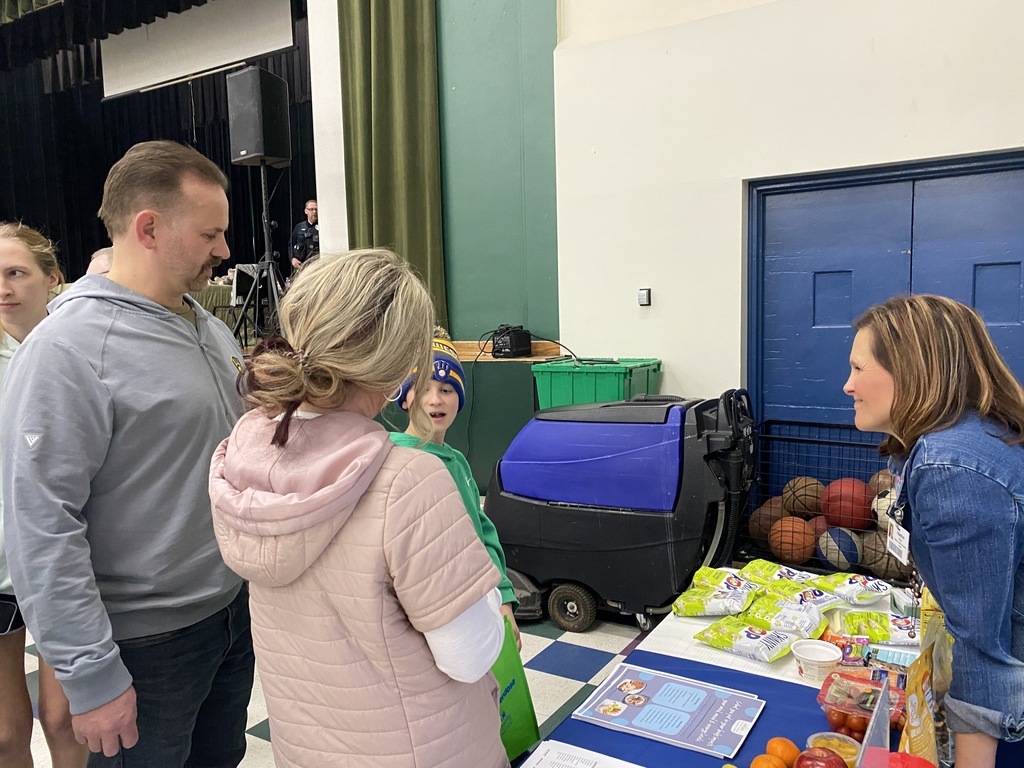 Families at Wellness Event visiting vendor tables.