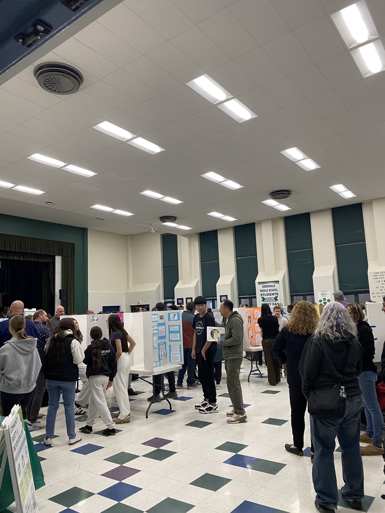 Crowd at Wellness Event visiting with 8th graders as they explain their presentation boards.