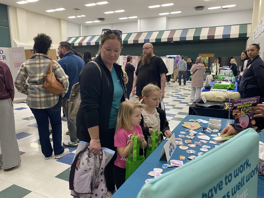 Families at Wellness Event visiting vendor tables.