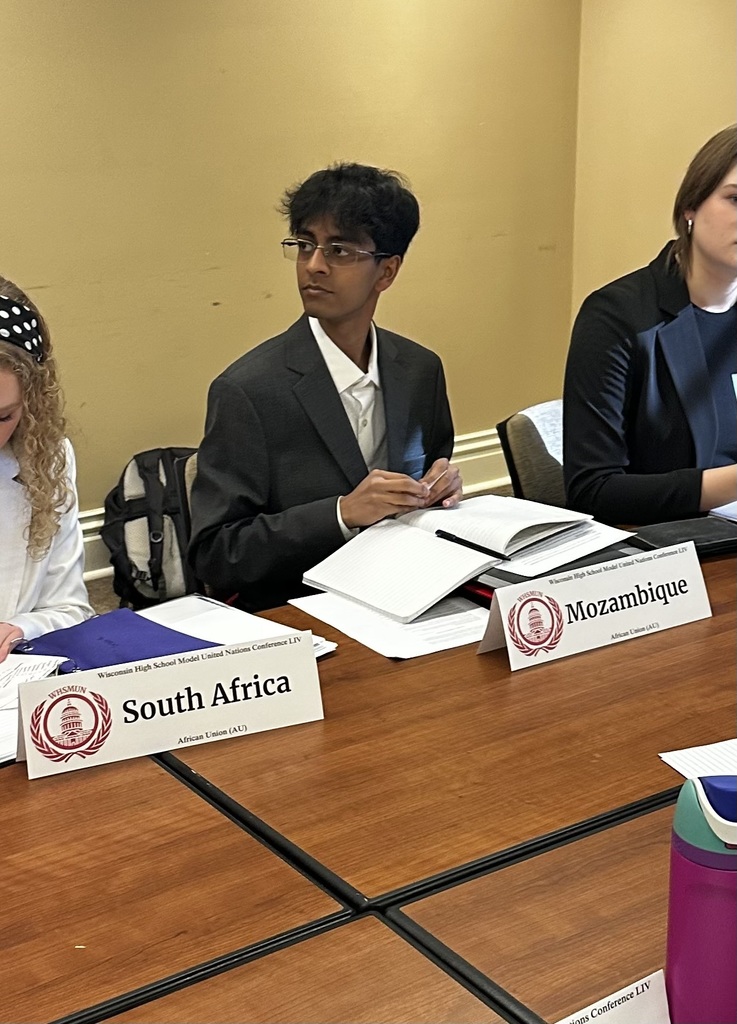 GHS students seated at desks listening during Model UN conference.