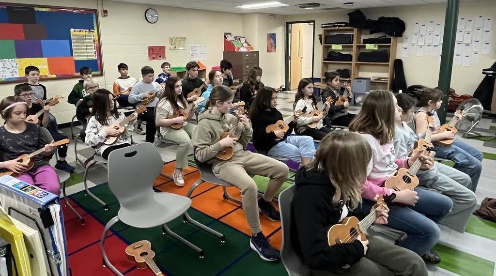 Students playing the ukulele in Music class.