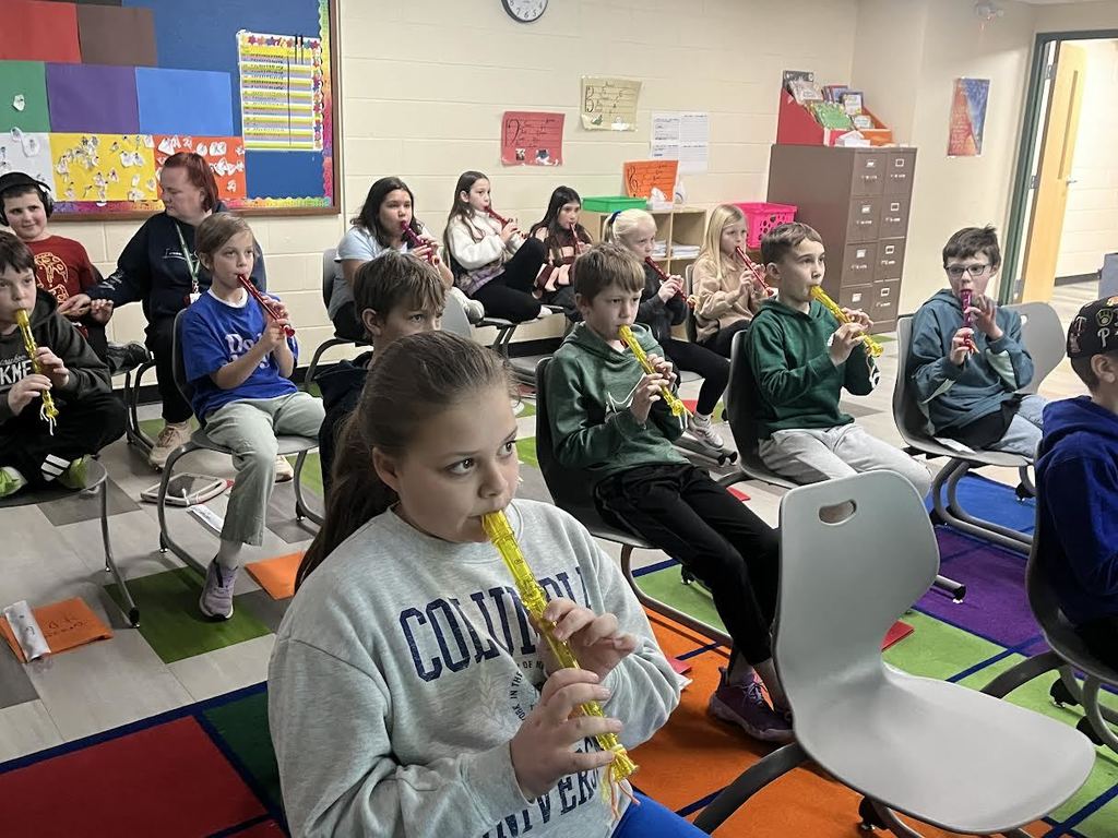 Students in Music class playing the recorder together.