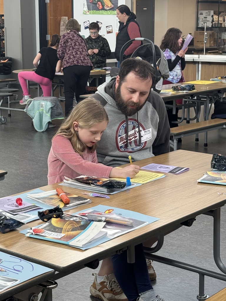 Third grader with family member demonstrating learning on Space.