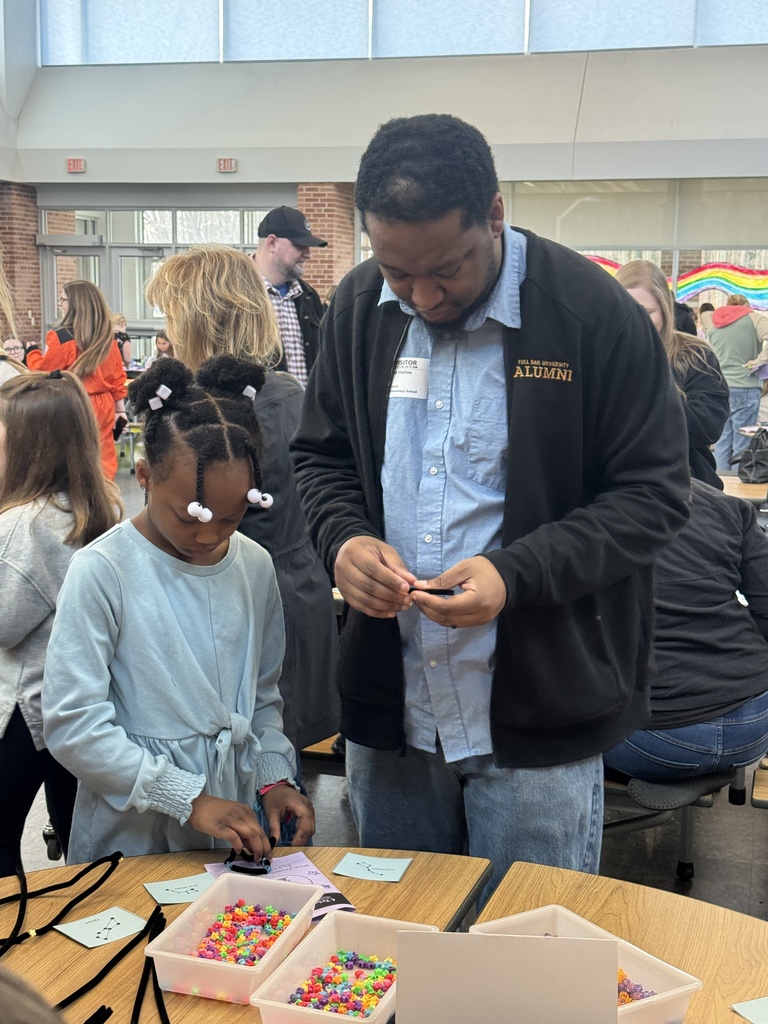 Third grader with family member demonstrating learning on Space.