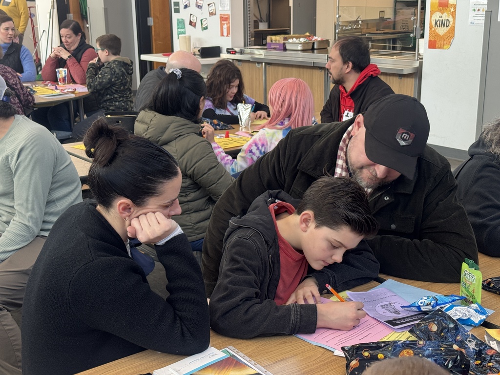 Third grader with family members demonstrating learning on Space.