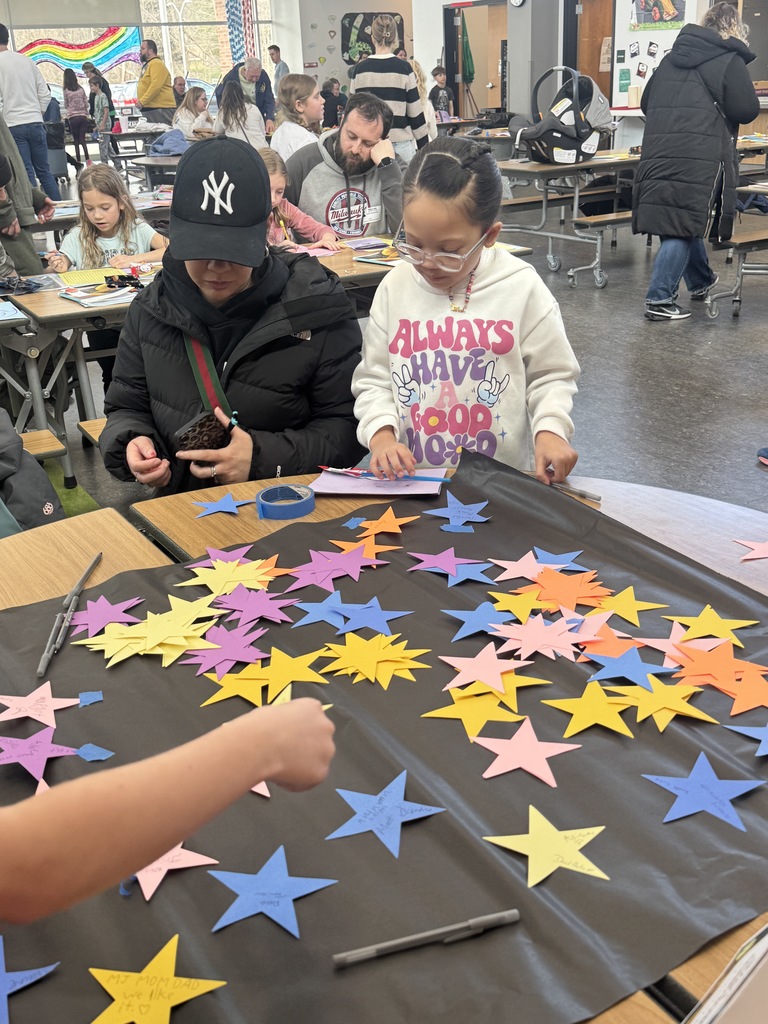 Third grader with family member demonstrating learning on Space.