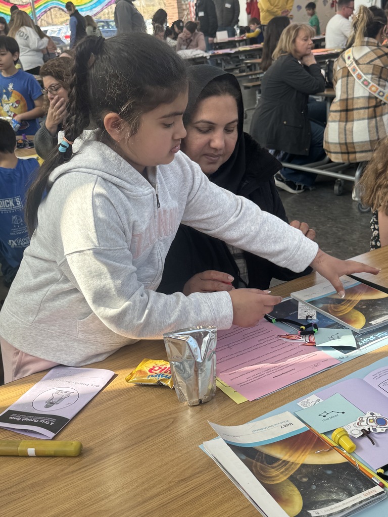Third grader with family member demonstrating learning on Space.