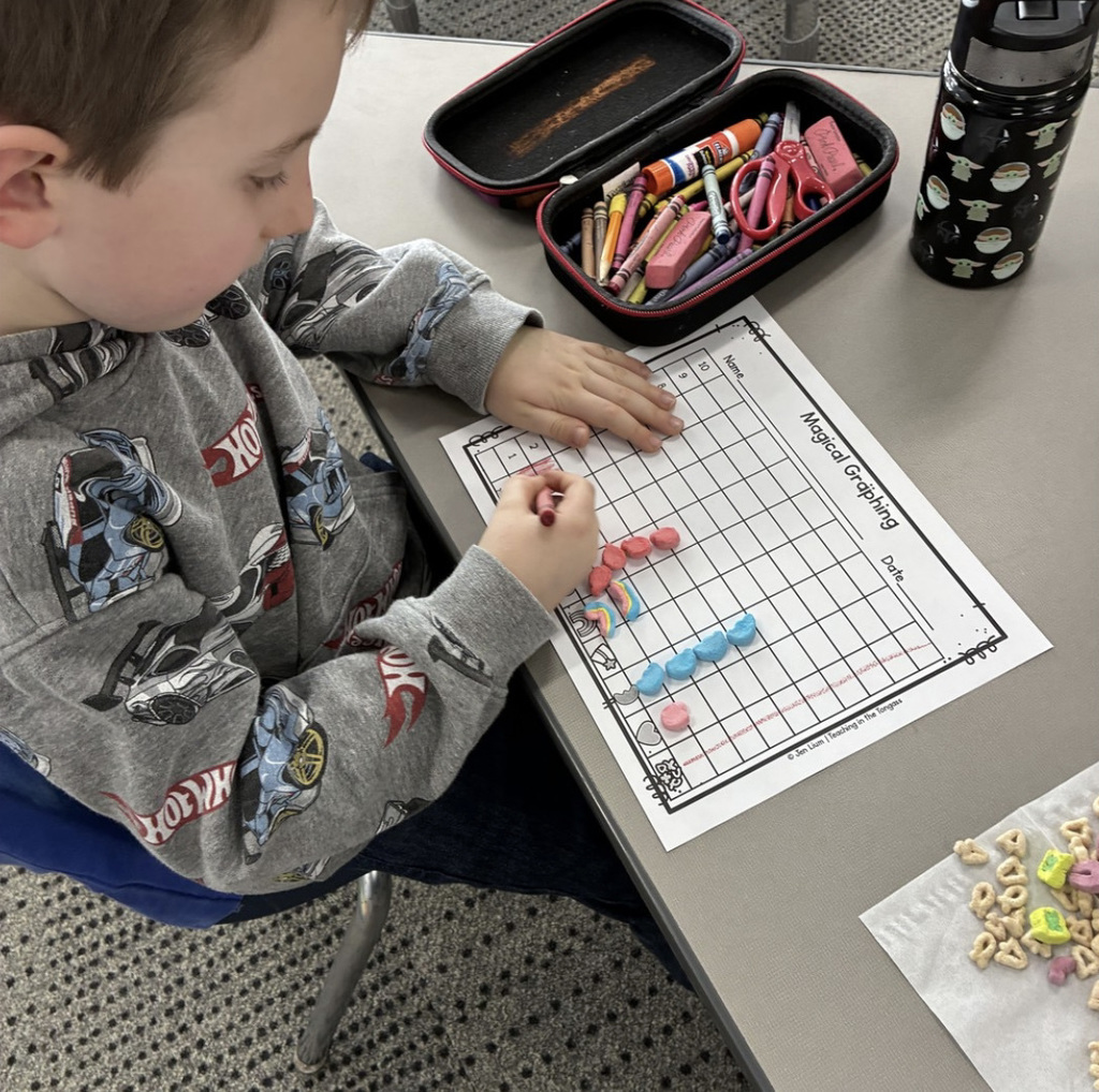 5K student graphing data using Lucky Charms marshmallows.