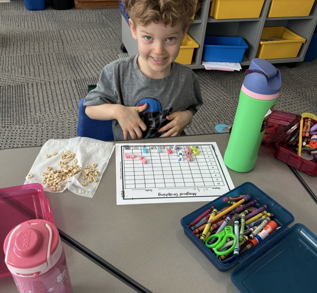 5K student graphing data using Lucky Charms marshmallows.