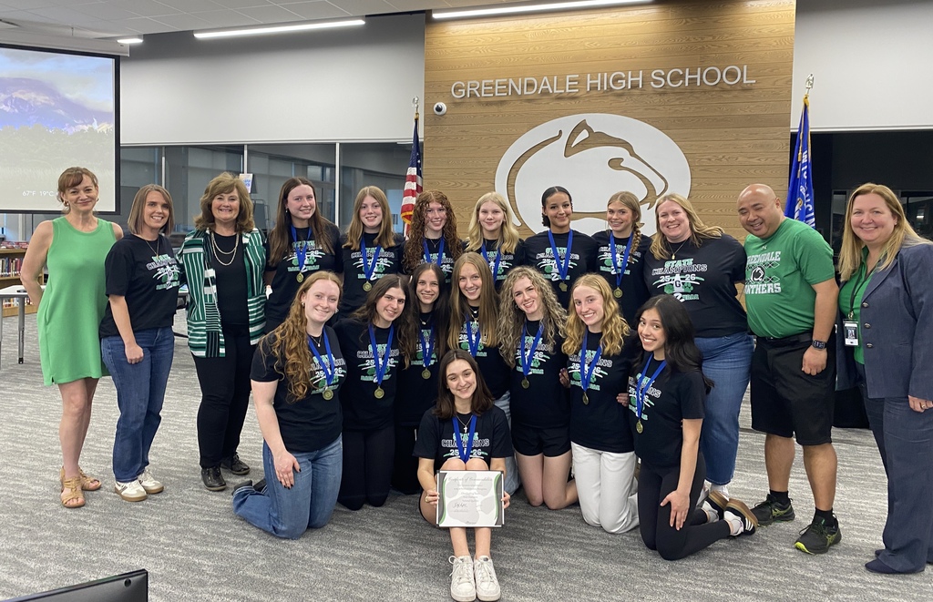 A group of people at Greendale High School, some wearing medals.