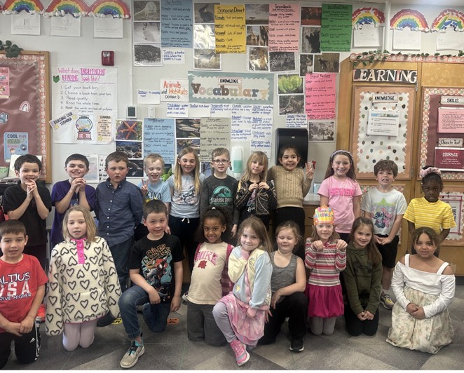 Group photo of first graders who have been studying animals habitats.