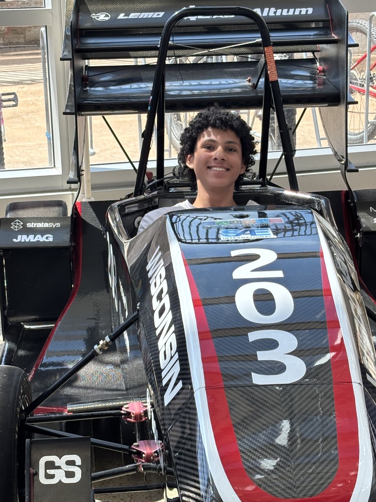 Open-wheel race car with number 03 on display indoors.