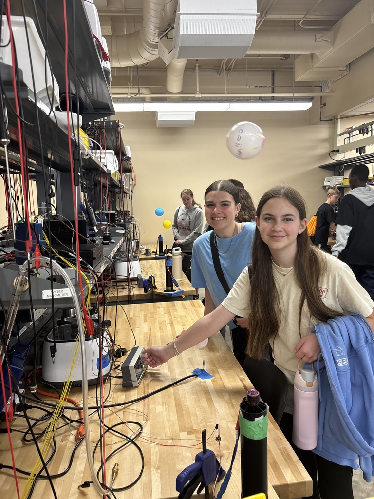 Students in a lab interacting with electronic equipment.