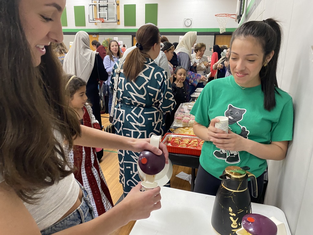 Girls pour coffee in small cups