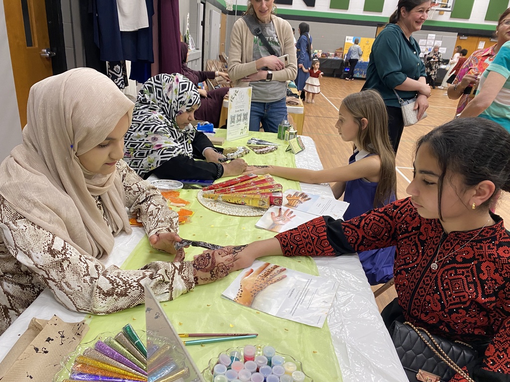 Ladies doing Henna on young girls hands