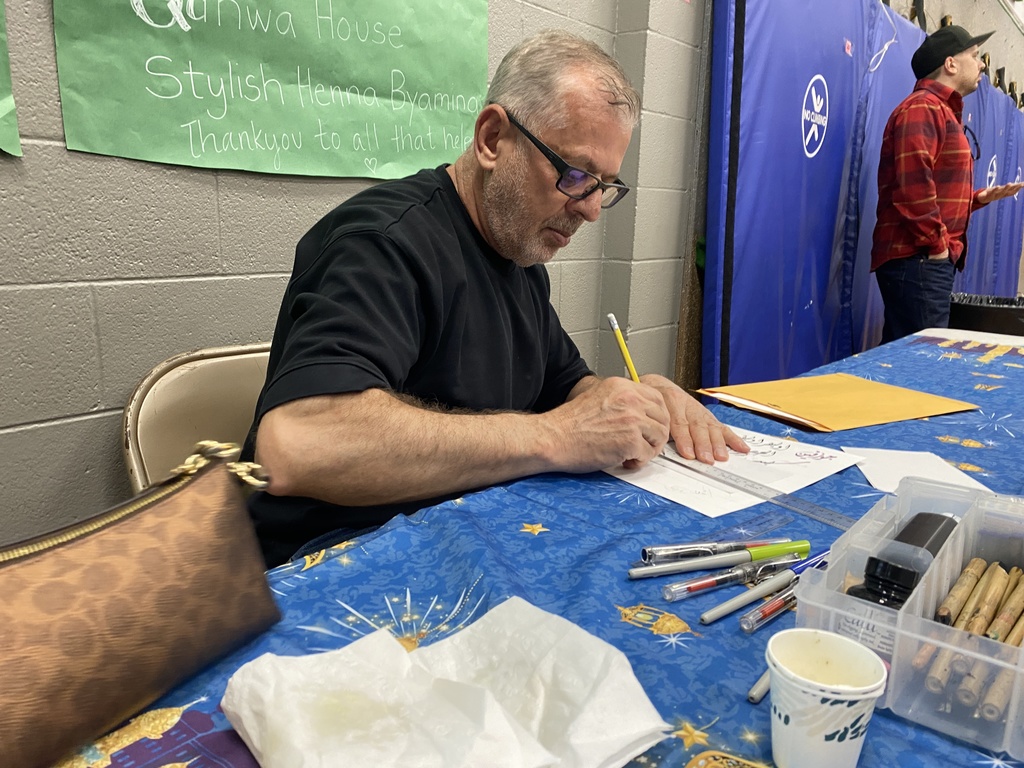 Man writing in Arabic